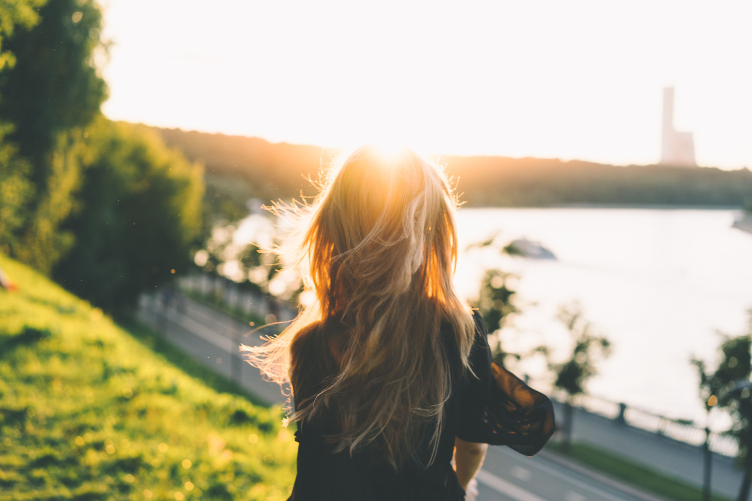 Woman walking by a river