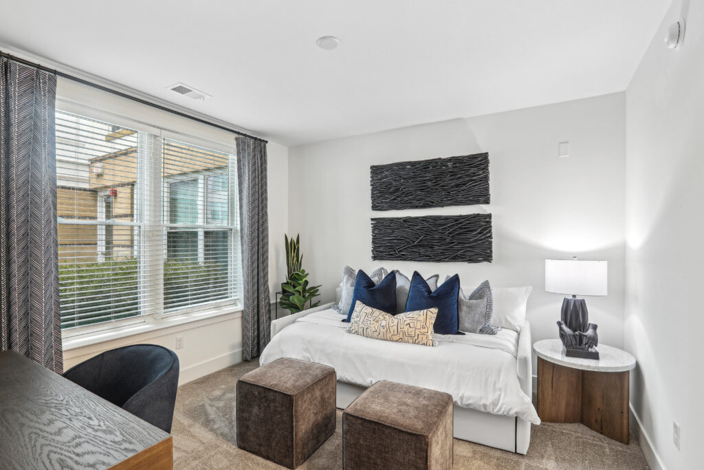 Carpeted bedroom with large windows