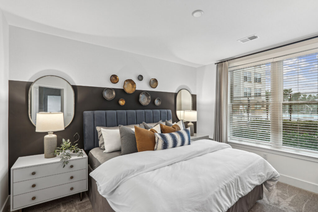 Carpeted bedroom with large windows