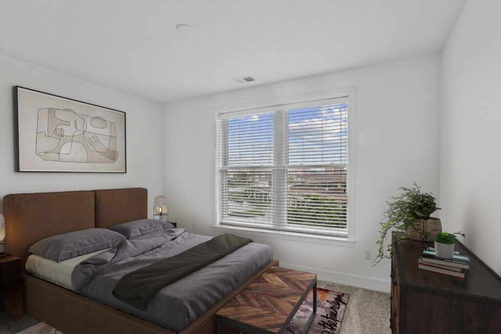 Carpeted bedroom with large window